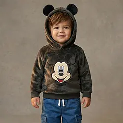 Kleinkind-Junge trägt einen Mickey-Mouse-Hoodie vor neutralem Hintergrund.